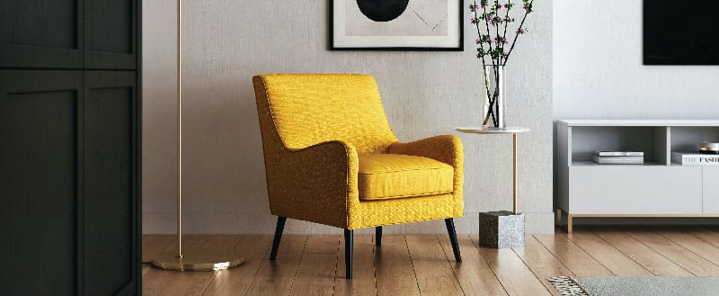 Uma cadeira amarela se destacando em um ambiente neutro, trazendo mais cores no ambiente.